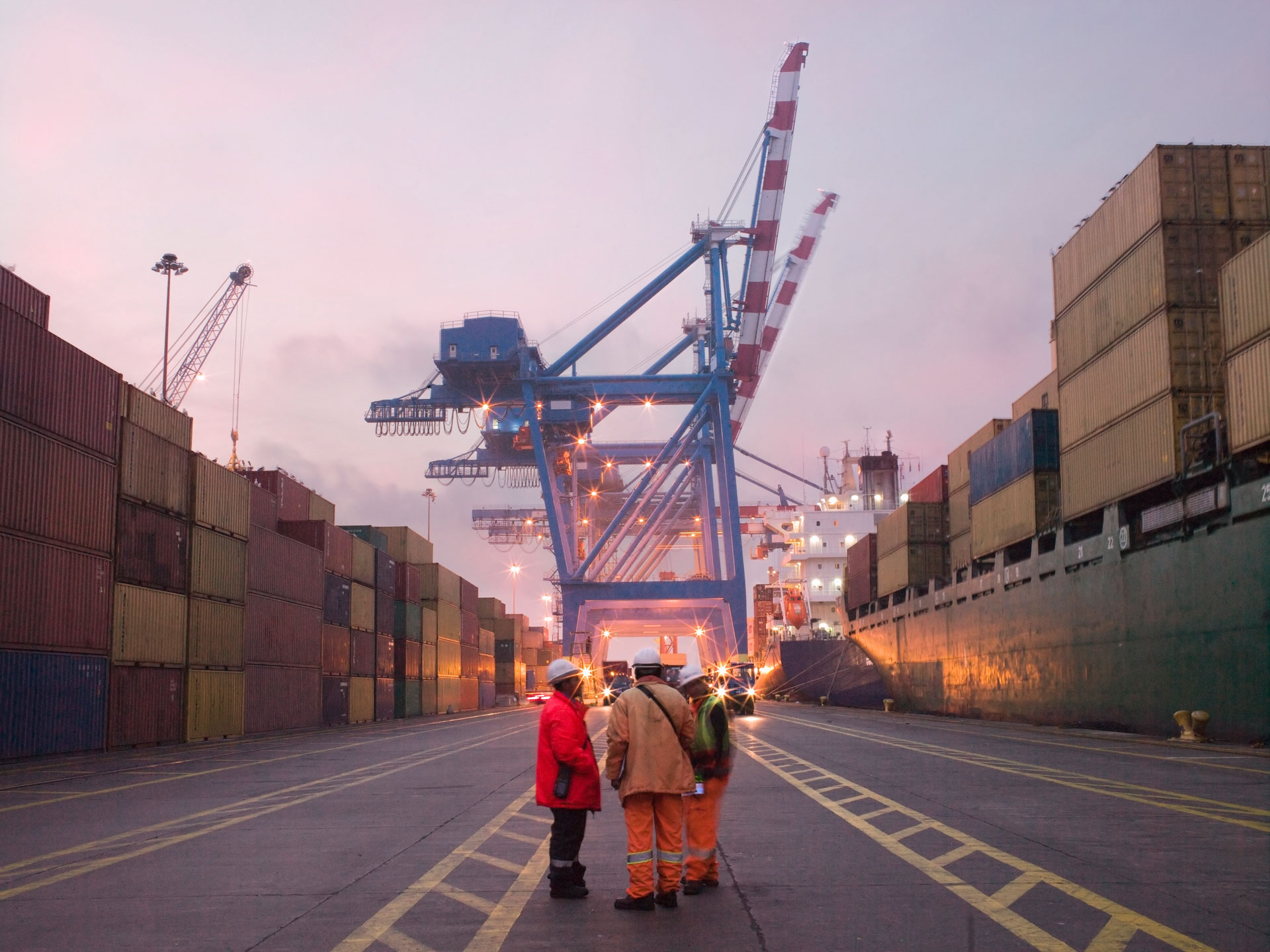 Workers talking in a shipping yard