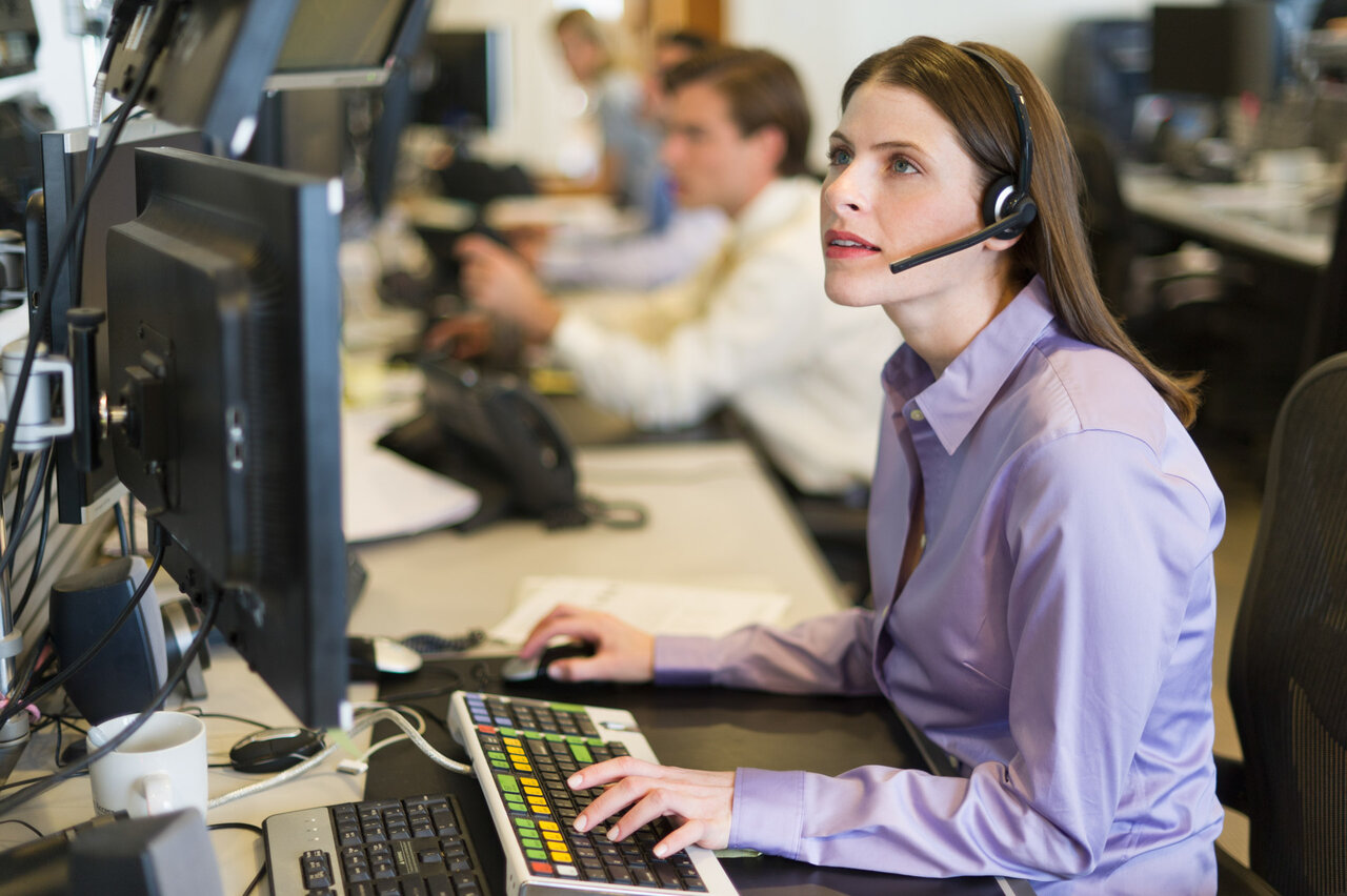 Young woman with headset working on a computer | © Tetra Images @Getty