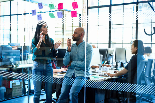People in an Office behind a glass wall