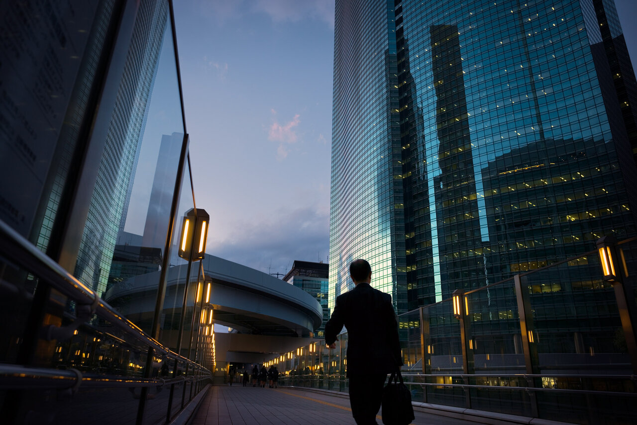 Evening commute with silhouette of businessman walking at Shiodome business district in Tokyo, Japan. | © EschCollection @GettyImages